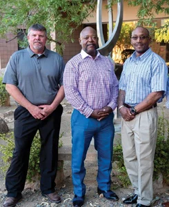 Three men standing together